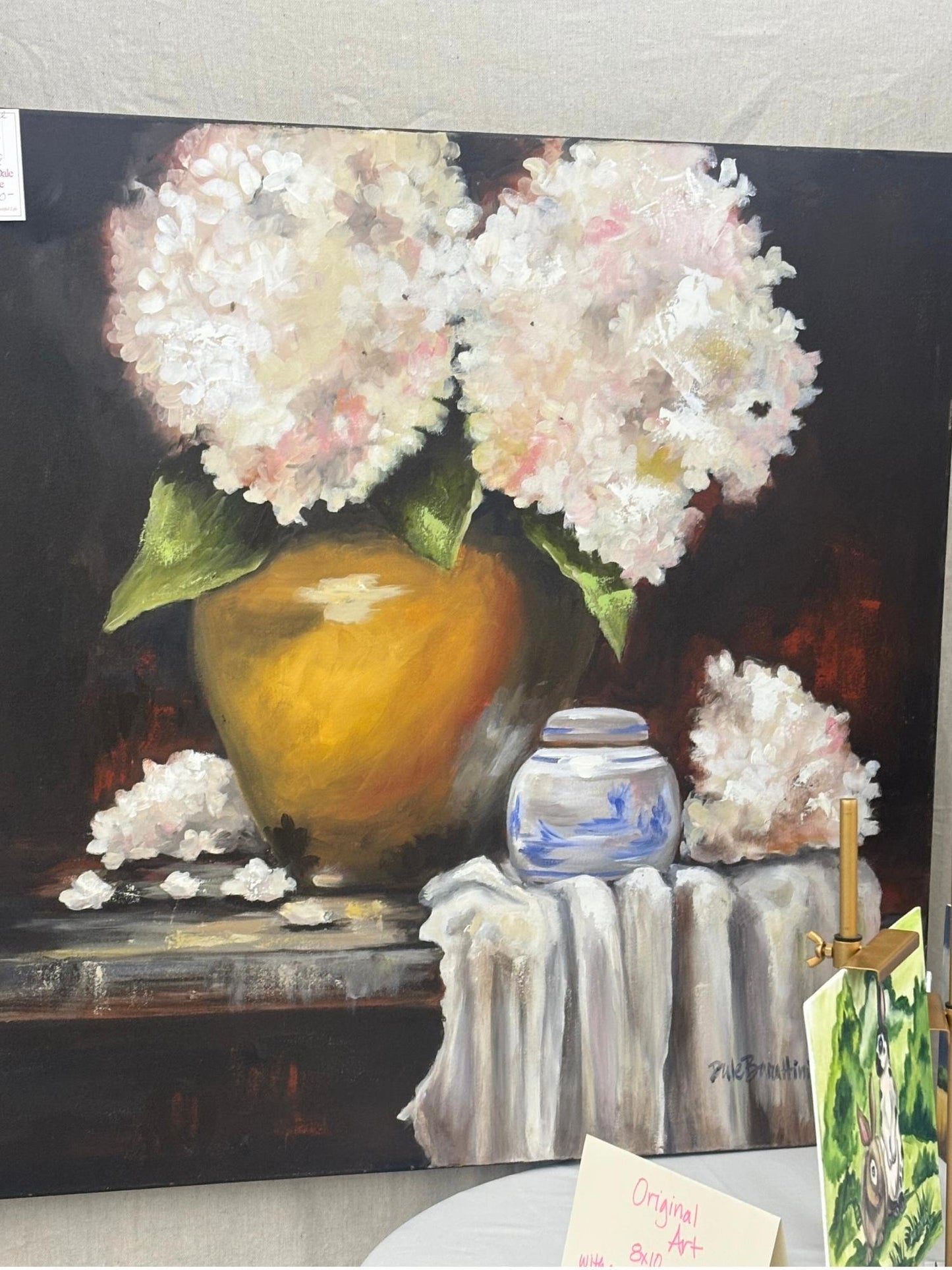 36x36 original acrylic painting of white hydrangeas in a gold vase beside a blue and white porcelain jar, on gallery-wrapped canvas.