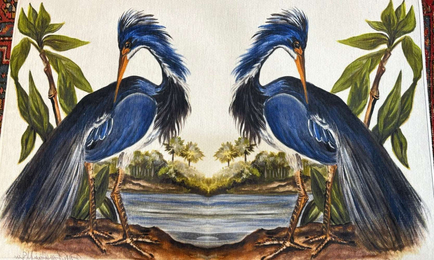 Hand-painted rug featuring two mirrored blue herons with long plumes, standing on either side of a coastal scene with palm trees and water, surrounded by green foliage.