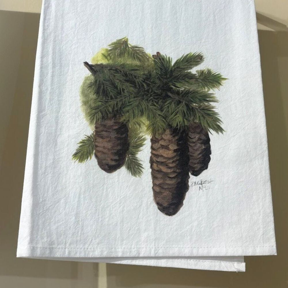 Tea towel with a realistic botanical illustration of pinecones and evergreen branches, evoking rustic woodland charm.