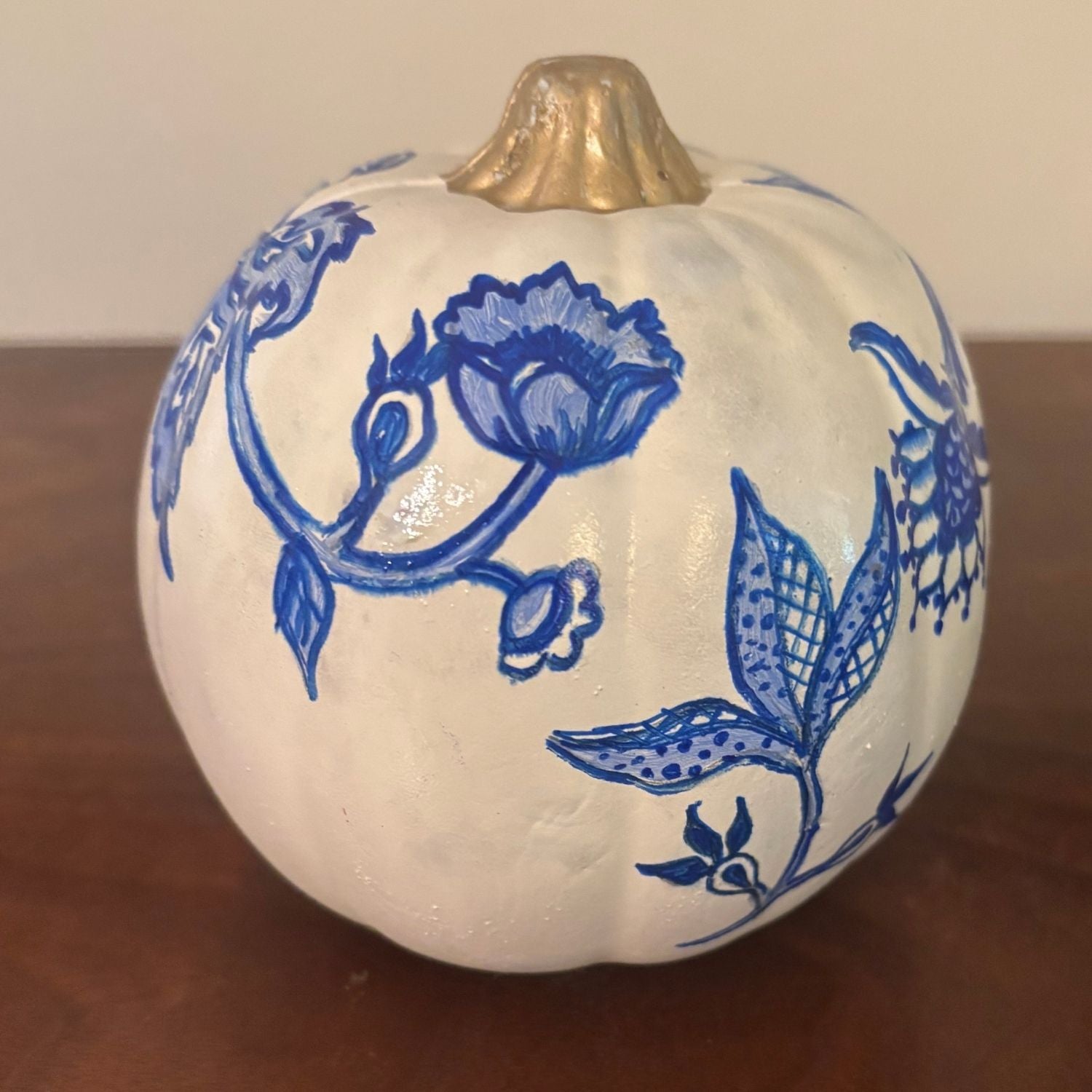 Rear view of the Lotus Bloom Pumpkin with delicate blue floral scrollwork and leafy detailing in traditional chinoiserie style.