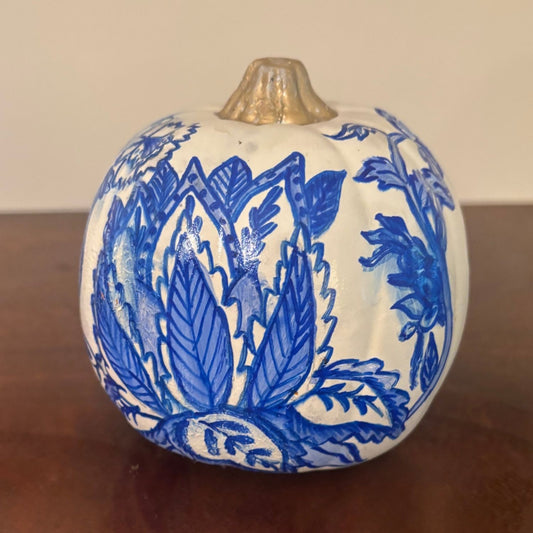 Close-up front view of the Lotus Bloom Pumpkin featuring hand-painted blue leaves in the shape of a lotus on a white background with a gold stem.