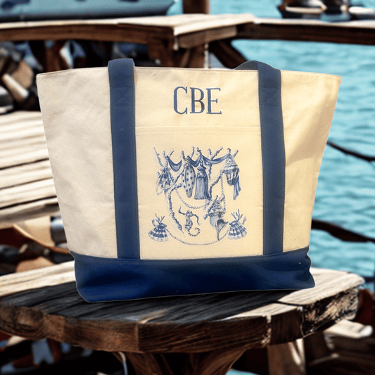 Monogrammed canvas tote bag with chinoiserie seashell design in blue, perfect for beach or coastal style.