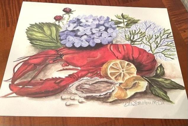 Photo of a paper placemat featuring lobster and hydrangea artwork on a table