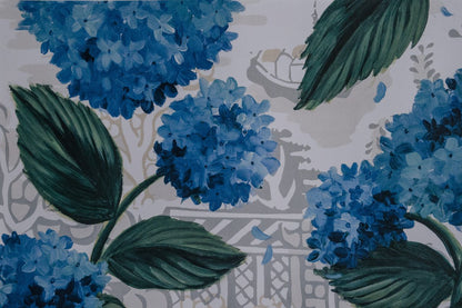 Up close photo of a paper placemat with blue hydrangea artwork