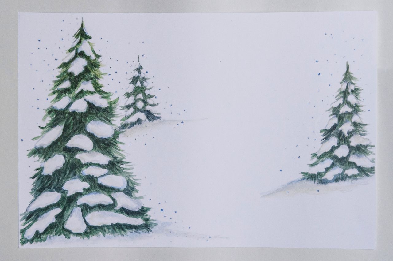 Photo of snowy evergreen tree paper placemats against a white background