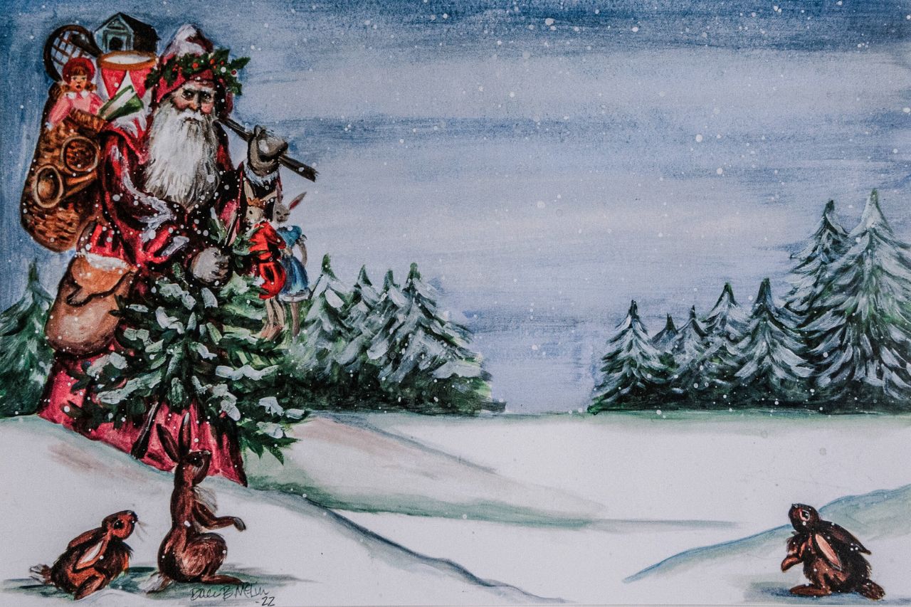 Up close photo of a paper placemat featuring festive mountain Santa carrying gifts through the snowy landscape