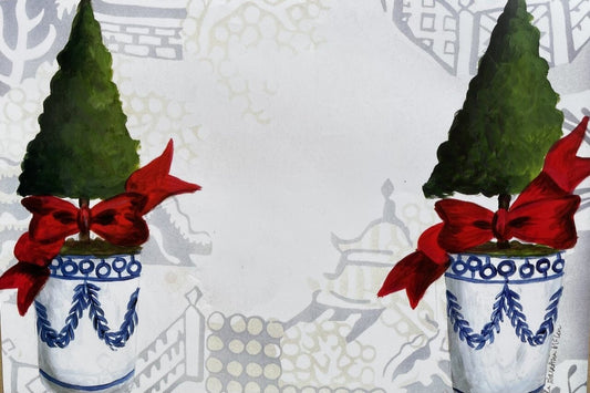 Up close photo of a paper placemat featuring a Christmas topiary design