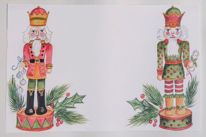 Photo of a paper placemat against a beige background. The artwork features two illustrated holiday nutcrackers