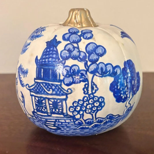Small 4-inch hand-painted pumpkin featuring a cobalt blue chinoiserie pagoda scene with gold stem.