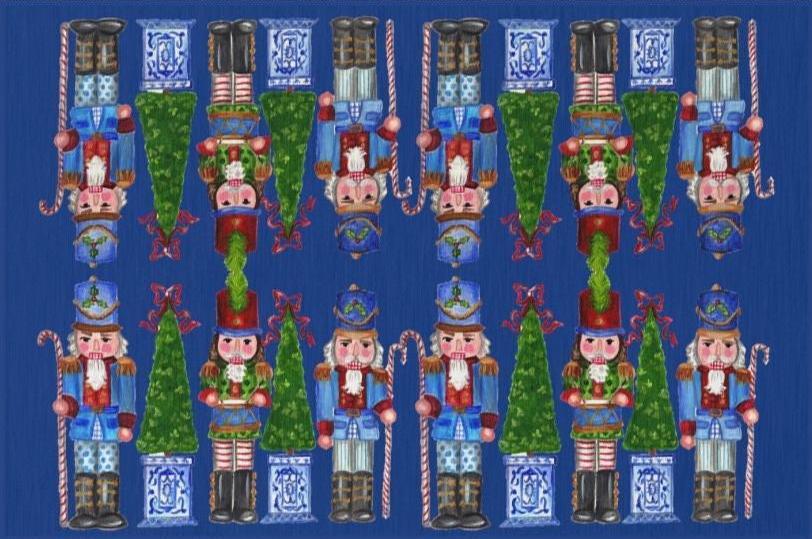 Photo of a whimsical holiday rug with a blue background featuring nutcrackers holding candy cane staffs and Christmas trees with a chinoiserie base