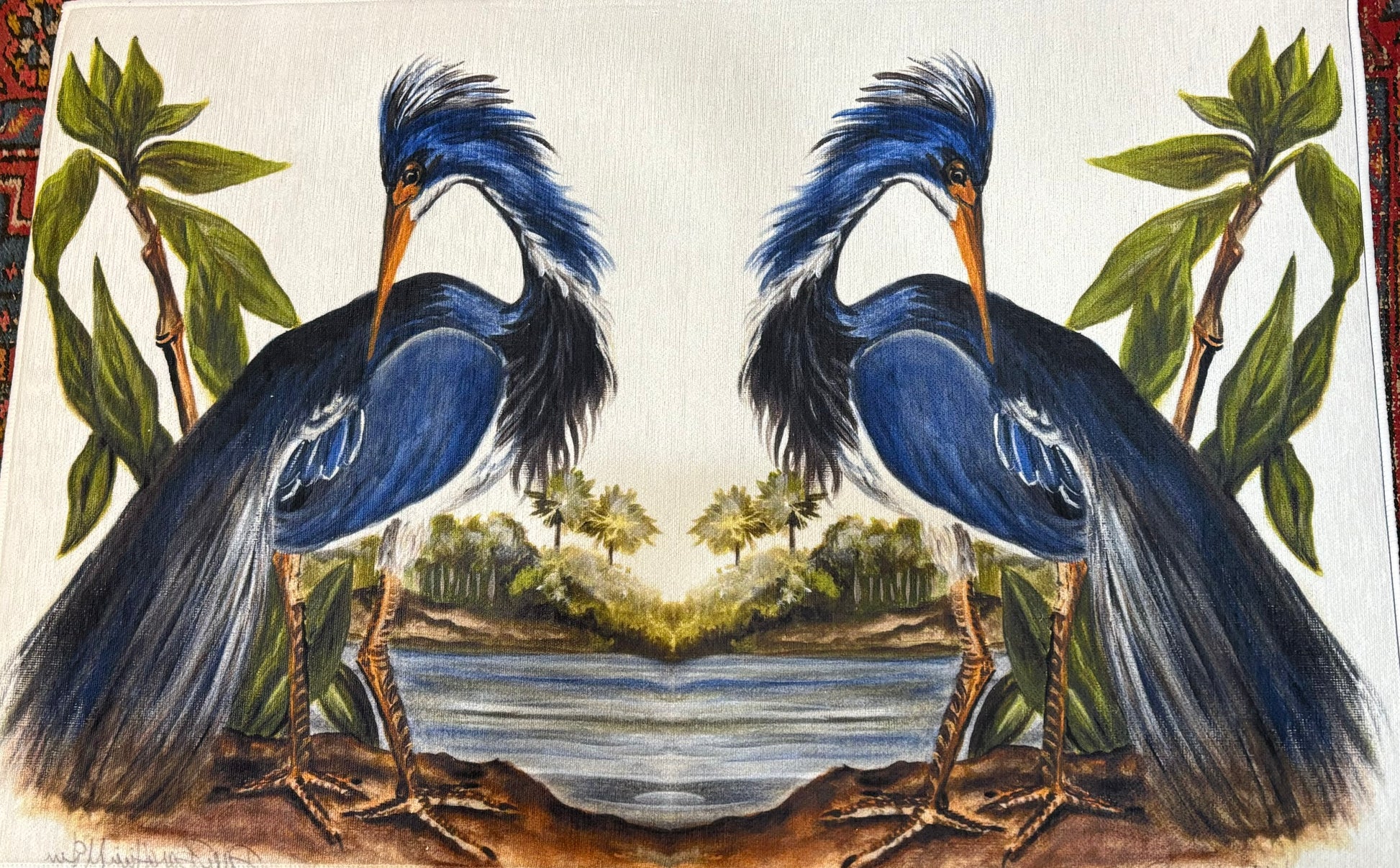 Photo of a rug against a red carpet featuring a mirror image of an egret at the water's edge