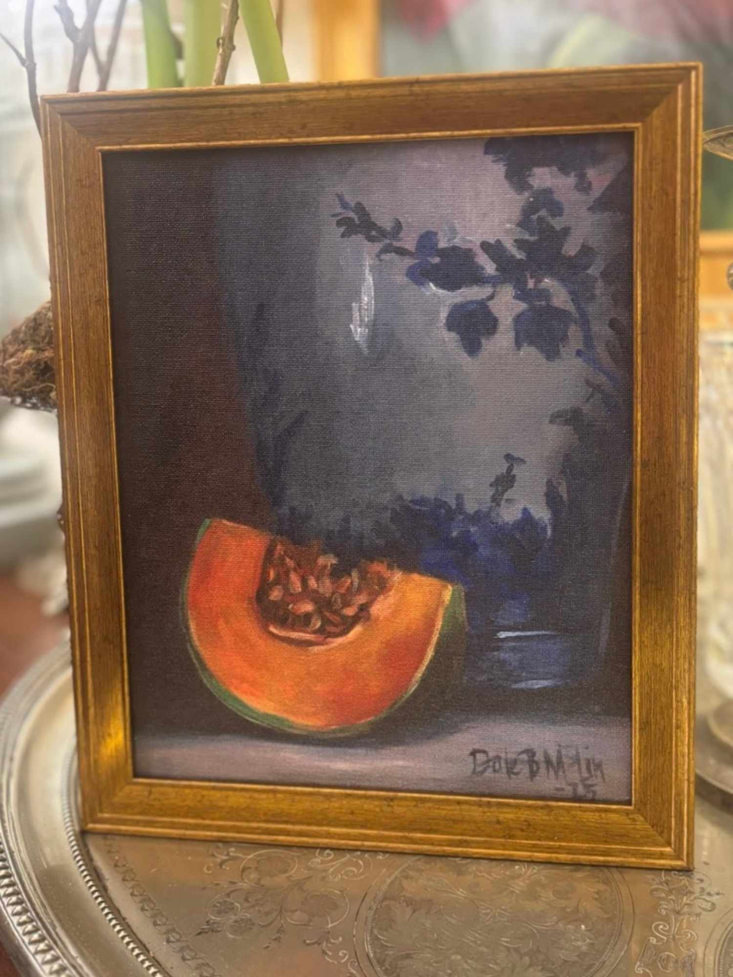 Framed painting of a cantaloupe slice and porcelain vase