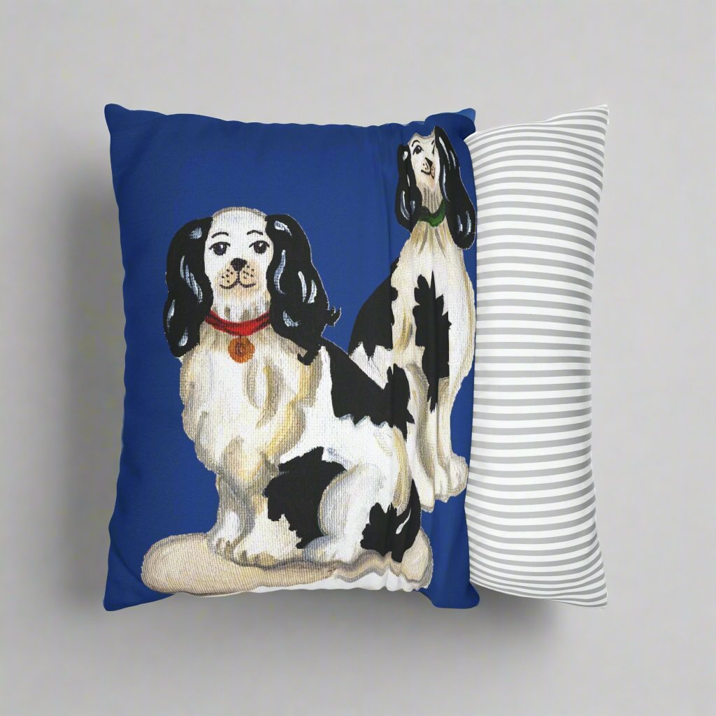 Photo of pillow case cover partially removed from the throw pillow. The canvas pillow case features two illustrated Staffordshire dogs with a blue background. 