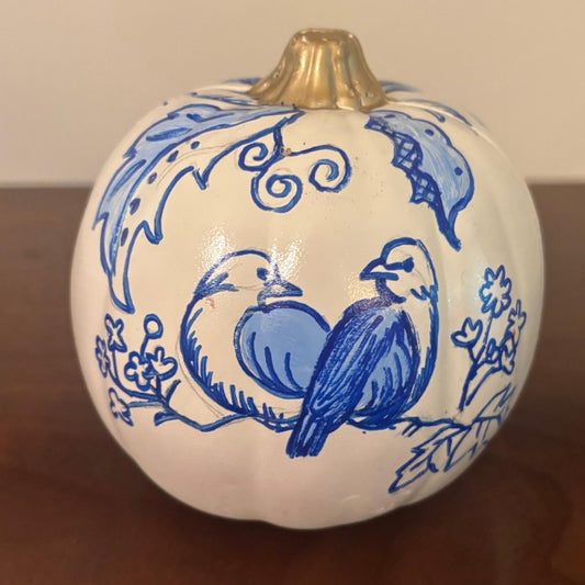 Hand-painted white chinoiserie pumpkin with two blue birds perched on a branch surrounded by florals.