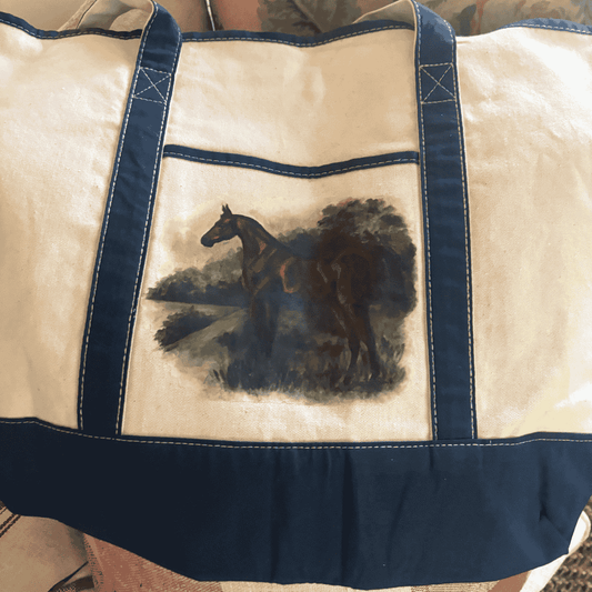 Canvas tote bag with navy trim featuring a hand-painted pastoral scene of a chestnut horse standing beside a tree-lined path, exuding country elegance.