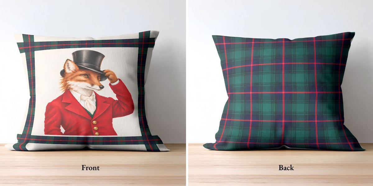 A square throw pillow shown from both front and back. The front features a white center with an illustration of a fox in a red jacket and top hat, bordered by a green and red tartan plaid pattern. The back features a green and red tartan plaid with hints of blue.