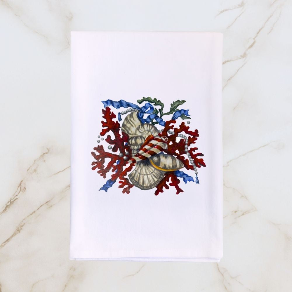 White Hill & Dale Home tea towel featuring Dale Barattini McLin artwork of red coral, seashells, pearls, and blue ribbon accents on a light marble background.