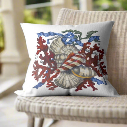 White throw pillow featuring Dale Barattini McLin artwork of red coral, seashells, pearls, and blue ribbon accents on a woven chair.
