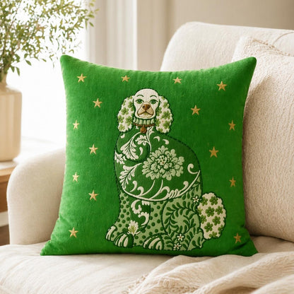 Green Staffordshire dog accent pillow with ornate floral details and gold stars, styled on a light upholstered chair with a cozy cream throw blanket.