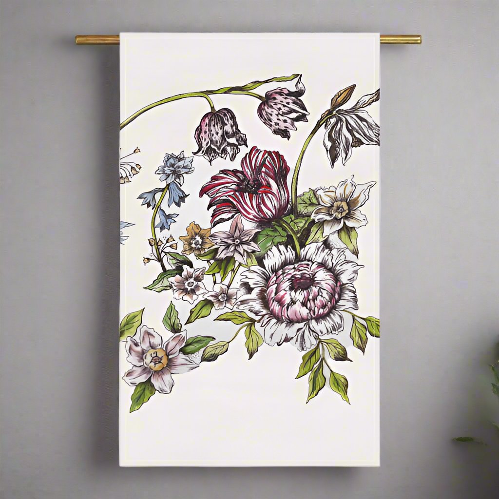 Image of a floral tea towel hanging on a bar against a light grey wall